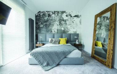 Grey bedroom interior with mirror